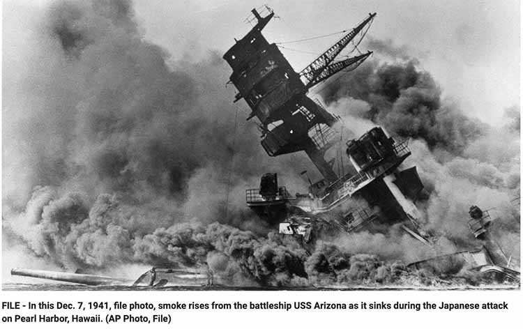 In this Dec. 7, 1941, file photo, smoke rises from the battleship USS Arizona as it sinks during the Japanese attack on Pearl Harbor, Hawaii